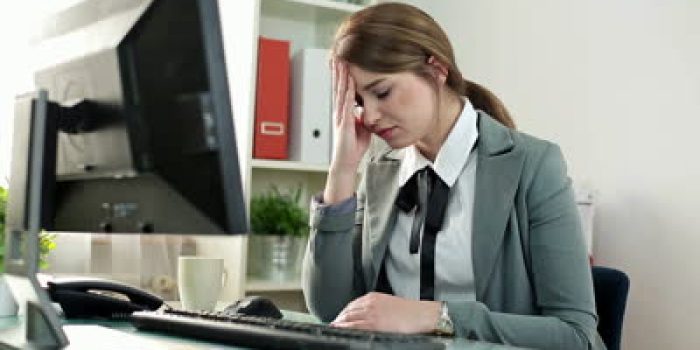 stock-footage-tired-businesswoman-having-headache-in-the-office
